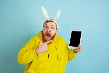 Image showing Easter bunny man with bright emotions on blue studio background