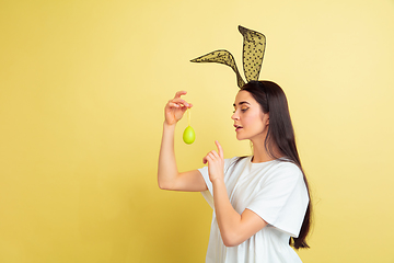 Image showing Easter bunny woman with bright emotions on yellow studio background