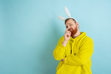 Image showing Easter bunny man with bright emotions on blue studio background