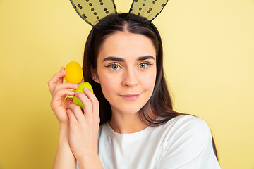 Image showing Easter bunny woman with bright emotions on yellow studio background