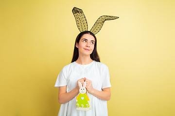 Image showing Easter bunny woman with bright emotions on yellow studio background