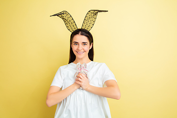 Image showing Easter bunny woman with bright emotions on yellow studio background