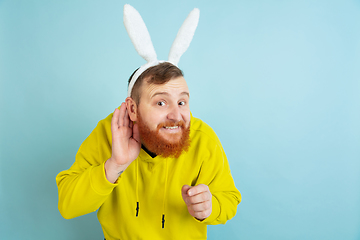 Image showing Easter bunny man with bright emotions on blue studio background