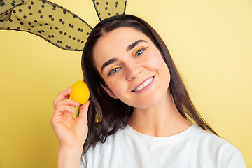 Image showing Easter bunny woman with bright emotions on yellow studio background