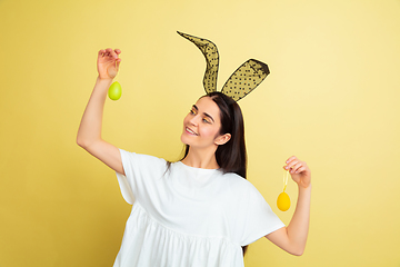 Image showing Easter bunny woman with bright emotions on yellow studio background