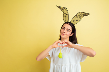 Image showing Easter bunny woman with bright emotions on yellow studio background