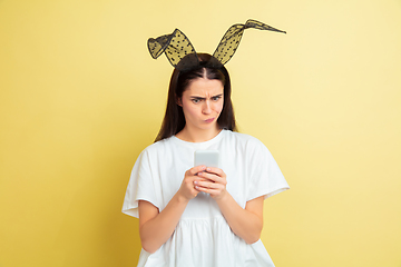 Image showing Easter bunny woman with bright emotions on yellow studio background