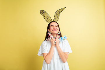 Image showing Easter bunny woman with bright emotions on yellow studio background