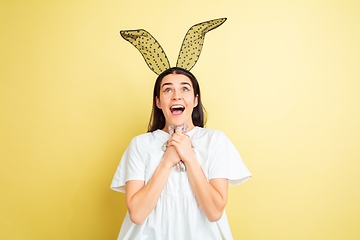 Image showing Easter bunny woman with bright emotions on yellow studio background