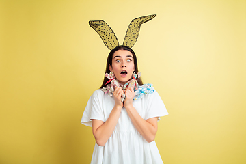 Image showing Easter bunny woman with bright emotions on yellow studio background