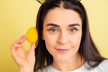 Image showing Easter bunny woman with bright emotions on yellow studio background