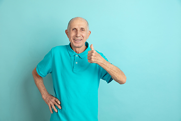 Image showing Caucasian senior man\'s portrait isolated on blue studio background