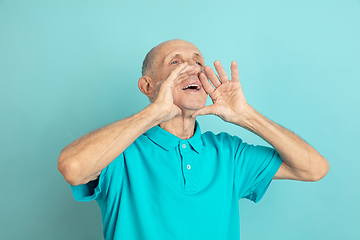 Image showing Caucasian senior man\'s portrait isolated on blue studio background