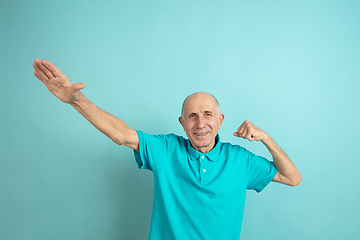 Image showing Caucasian senior man\'s portrait isolated on blue studio background