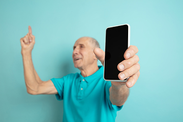 Image showing Caucasian senior man\'s portrait isolated on blue studio background