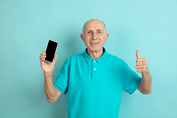 Image showing Caucasian senior man\'s portrait isolated on blue studio background