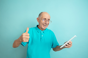 Image showing Caucasian senior man\'s portrait isolated on blue studio background