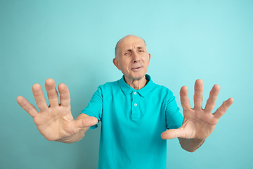 Image showing Caucasian senior man\'s portrait isolated on blue studio background