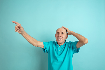 Image showing Caucasian senior man\'s portrait isolated on blue studio background