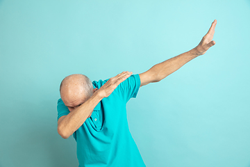 Image showing Caucasian senior man\'s portrait isolated on blue studio background