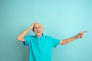 Image showing Caucasian senior man\'s portrait isolated on blue studio background