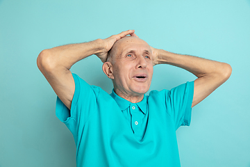 Image showing Caucasian senior man\'s portrait isolated on blue studio background