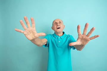 Image showing Caucasian senior man\'s portrait isolated on blue studio background