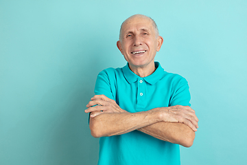 Image showing Caucasian senior man\'s portrait isolated on blue studio background