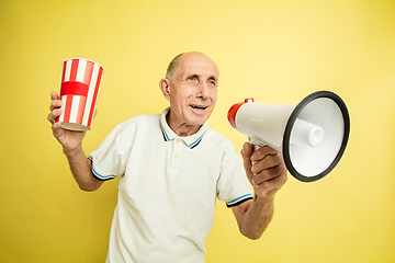 Image showing Caucasian senior man\'s portrait isolated on yellow studio background