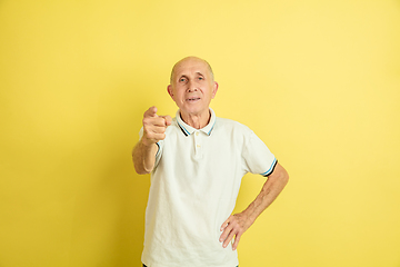 Image showing Caucasian senior man\'s portrait isolated on yellow studio background