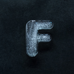 Image showing Alphabet\'s letters made out of ice isolated on dark studio background