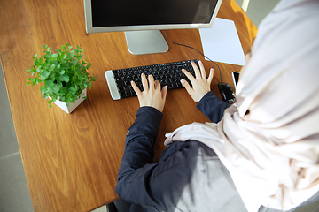 Image showing Portrait of a beautiful arabian businesswoman wearing hijab while working