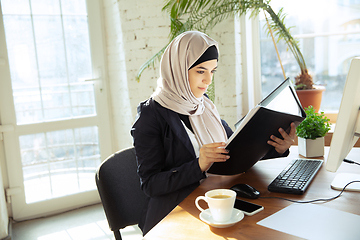 Image showing Portrait of a beautiful arabian businesswoman wearing hijab while working