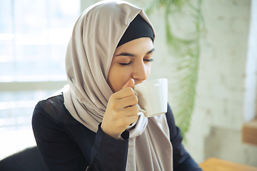 Image showing Portrait of a beautiful arabian businesswoman wearing hijab while working