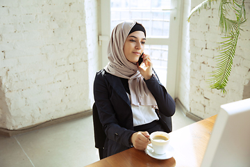 Image showing Portrait of a beautiful arabian businesswoman wearing hijab while working