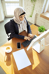 Image showing Portrait of a beautiful arabian businesswoman wearing hijab while working