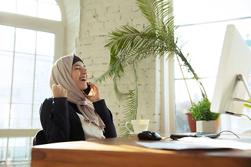 Image showing Portrait of a beautiful arabian businesswoman wearing hijab while working