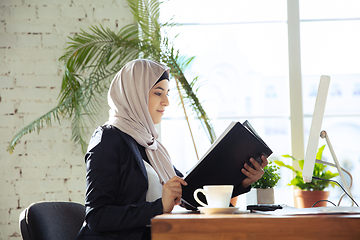 Image showing Portrait of a beautiful arabian businesswoman wearing hijab while working