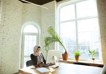 Image showing Portrait of a beautiful arabian businesswoman wearing hijab while working