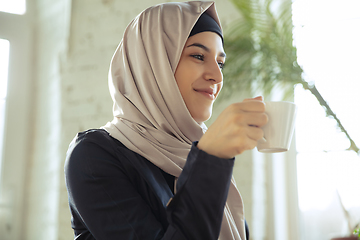 Image showing Portrait of a beautiful arabian businesswoman wearing hijab while working