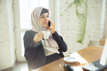 Image showing Portrait of a beautiful arabian businesswoman wearing hijab while working