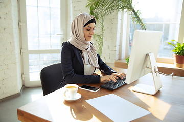 Image showing Portrait of a beautiful arabian businesswoman wearing hijab while working