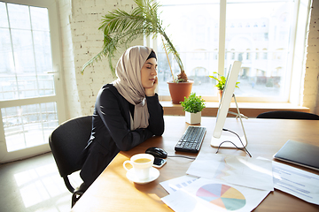 Image showing Portrait of a beautiful arabian businesswoman wearing hijab while working