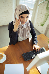 Image showing Portrait of a beautiful arabian businesswoman wearing hijab while working