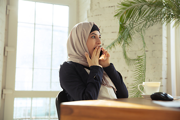 Image showing Portrait of a beautiful arabian businesswoman wearing hijab while working