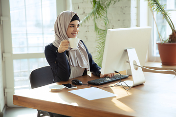 Image showing Portrait of a beautiful arabian businesswoman wearing hijab while working