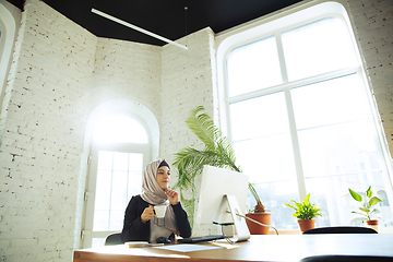 Image showing Portrait of a beautiful arabian businesswoman wearing hijab while working