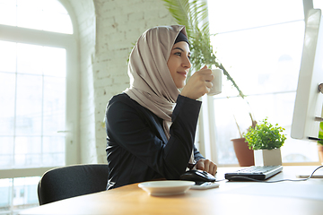 Image showing Portrait of a beautiful arabian businesswoman wearing hijab while working