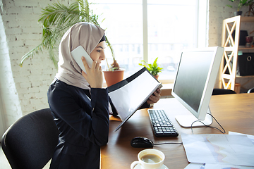 Image showing Portrait of a beautiful arabian businesswoman wearing hijab while working