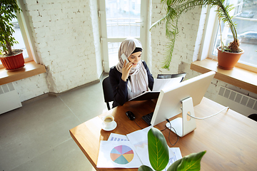 Image showing Portrait of a beautiful arabian businesswoman wearing hijab while working